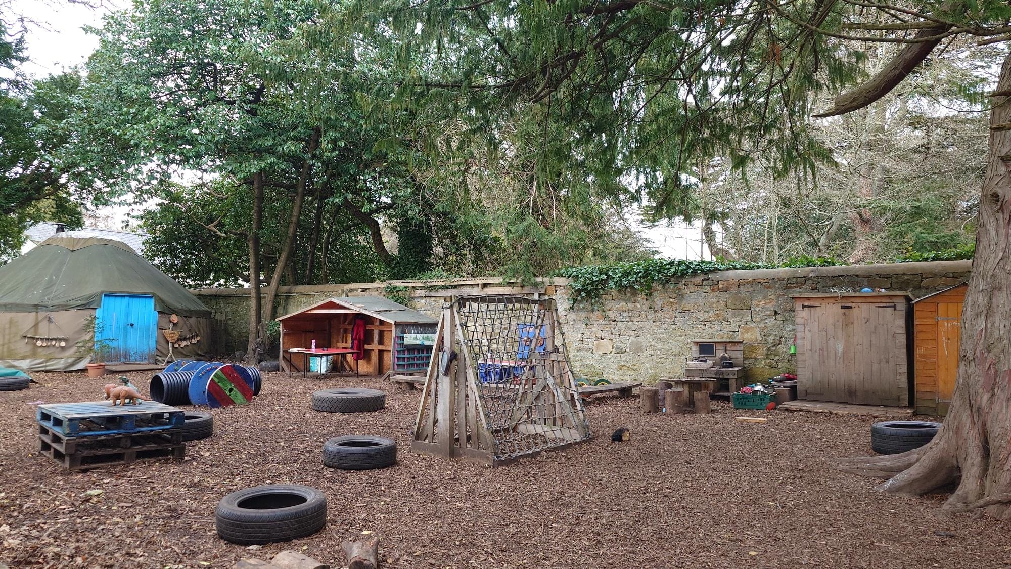 Yurt and surrounding area with loose parts play